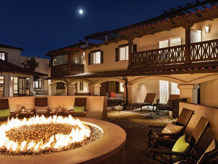 Hotel Exterior and Patio Area with Seats Around a Fire Pit