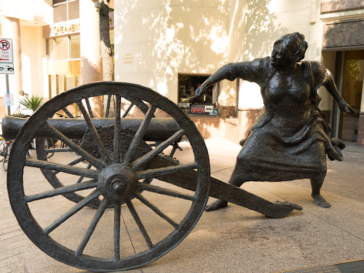 Statue of a Woman with a Cannon at Cannon and Belle Restaurant