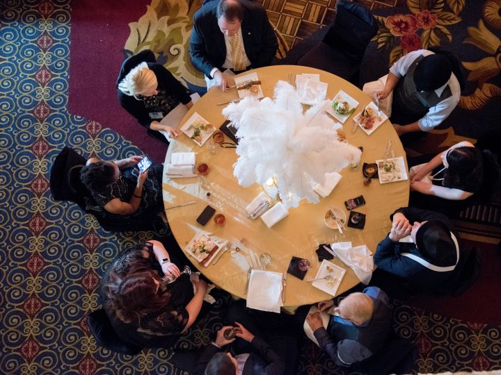 View from above of a group of people dining on a round table