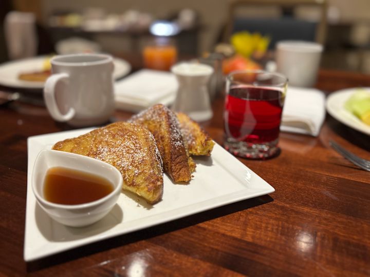 Poached restaurant, french toast plate, juice, coffee