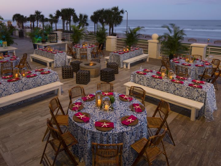 Outdoor Patio Area with Dining Tables, Chairs and Ocean View