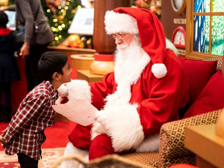 little boy talking to Santa