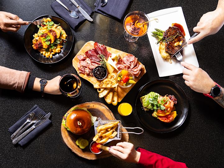 multiple plates of food on black