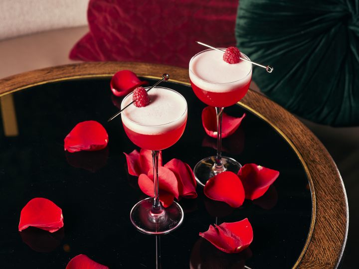Pink Cocktails with a raspberry and rose petals