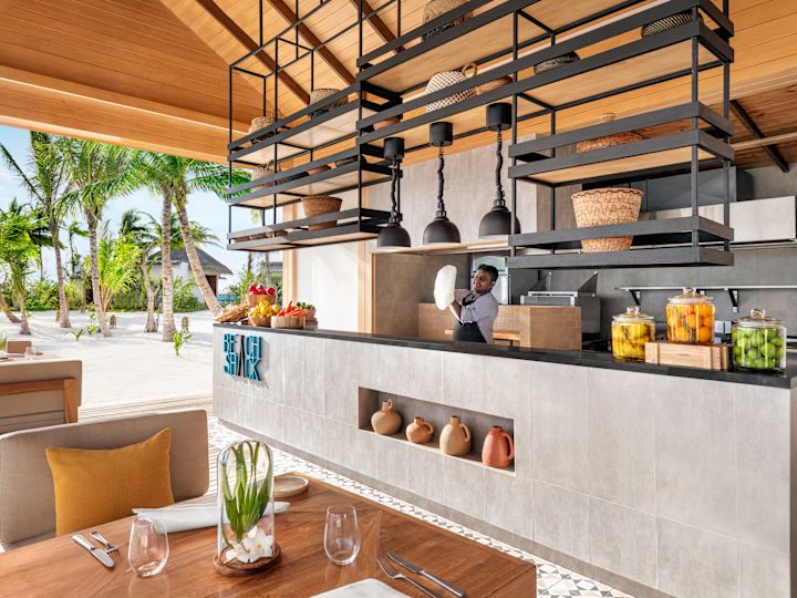 indoor and outdoor dining establishment with staff behind food counter