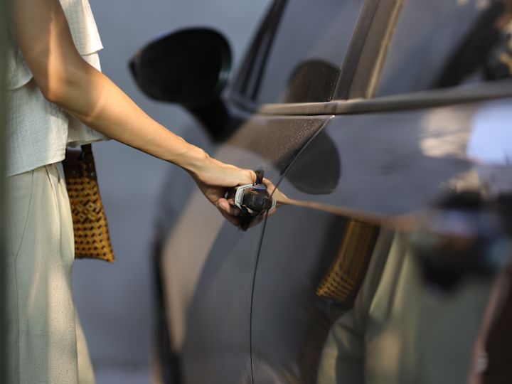 person getting into car