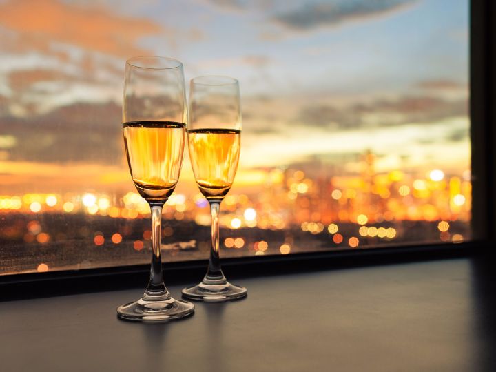 Two champagne glasses overlooking sunset