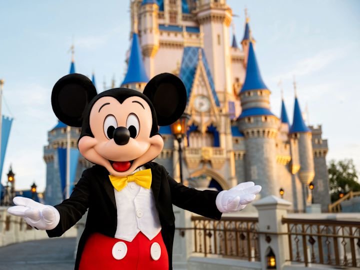 Imagine cu Mickey Mouse în fața castelului Disney