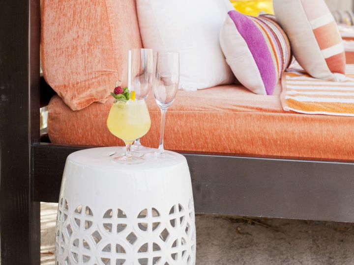 Cocktail and 2 glasses sitting by comfortable lounger