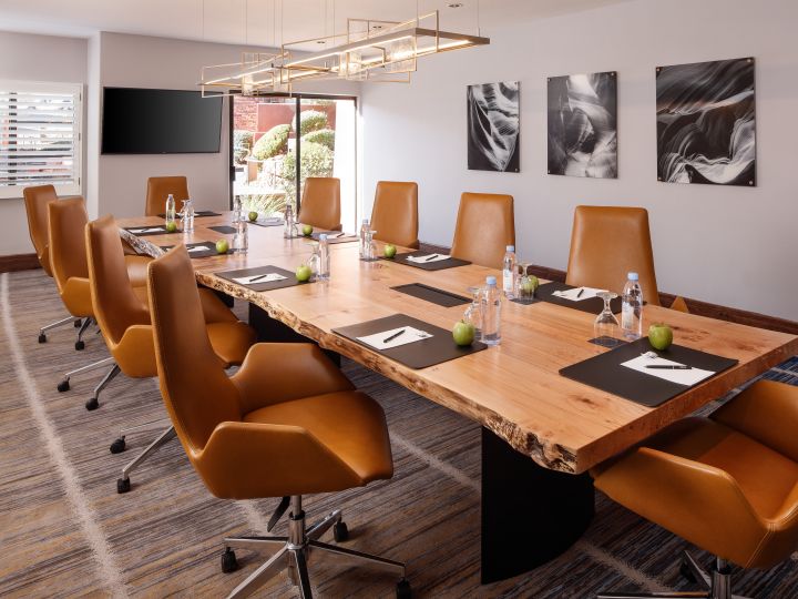 Boardroom with Large Meeting Table, Office Chairs and Wall Mounted HDTV
