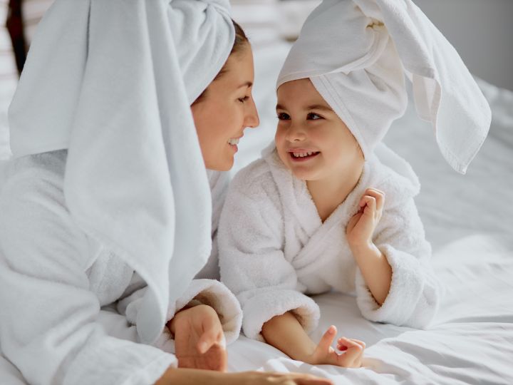 Girls in bathrobes on bed