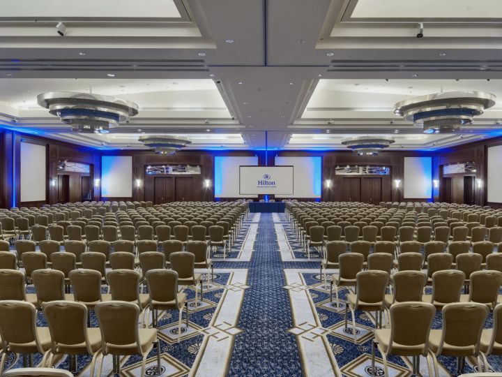 Large meeting room set up for event with chairs
