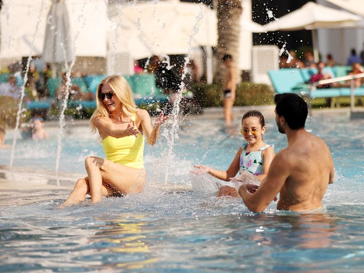Family Enjoying a Day in Outdoor Pool