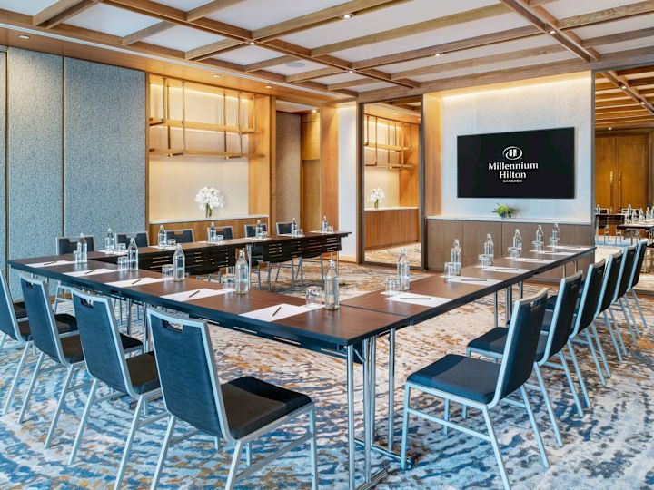 Hollow Square Style Conference Setup in a Room with a TV