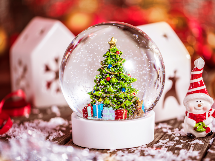 a Christmas Snow Globe and Other Decorations on a Table