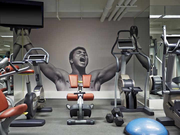 Fitness center with cardio machines, bench and TV