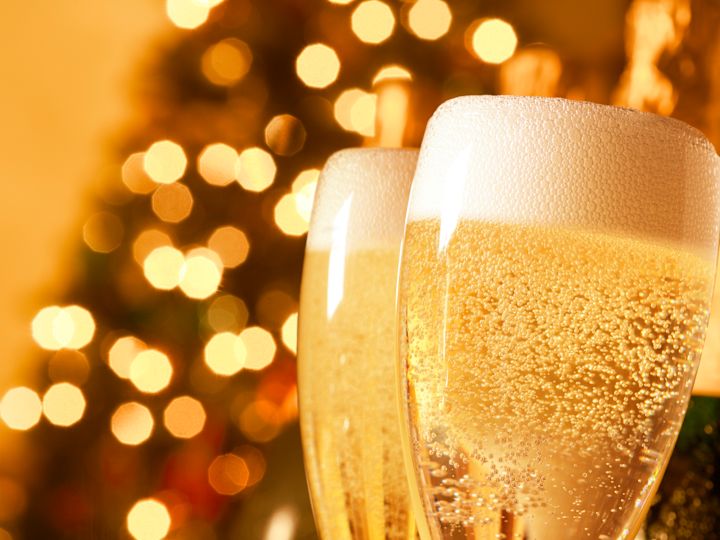 Detailed View of Two Glasses of Champagne With Lights in the Background