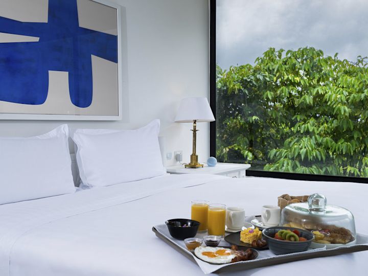 A tray of food sitting on the bed in the master bedroom.