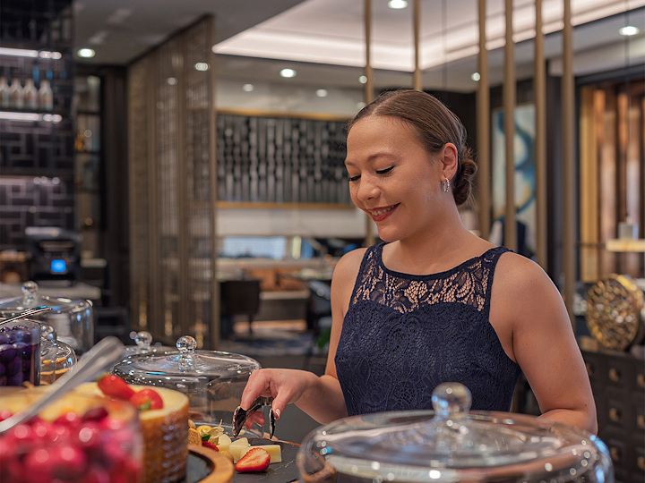 Close-up of woman at breakfast bar