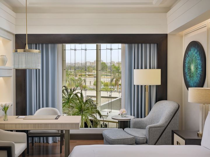 Desk and Armchair in a Guest Room with a Large Window