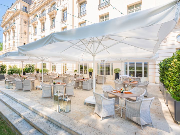 View of a Terrace with Tables and Chairs under Umbrellas