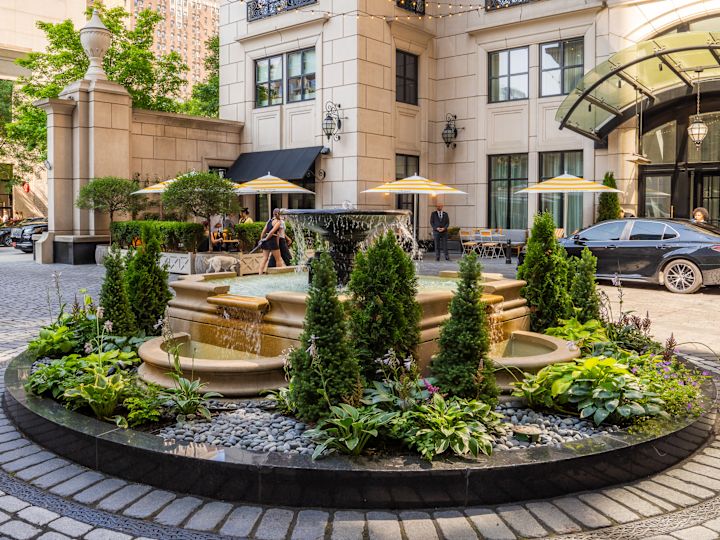 People Sitting in the Courtyard, and View of the Hotel Entance