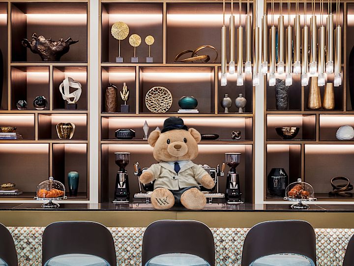 Bear on top of bar with bar stool seating in front