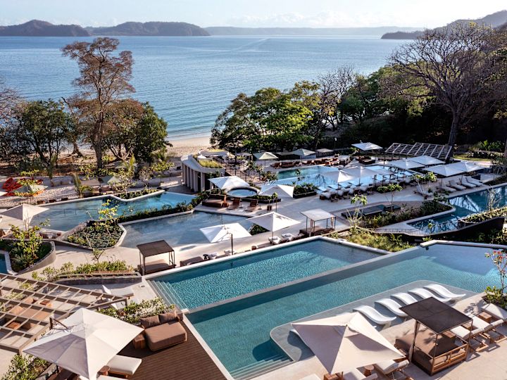 View of Outdoor Pools and Beach in Background