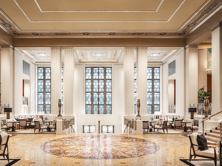 Luxurious lobby area with chairs, pillars and staircases