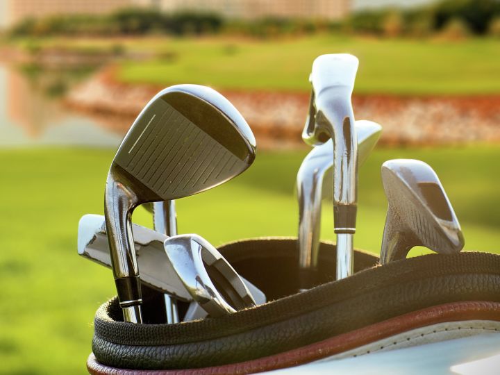 Close-Up on Clubs in Golf Bag on Course