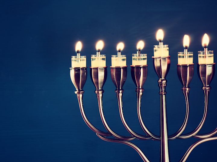 Close View of a Menorah with Lit Candles for a Festive Celebration