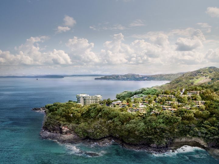 View of property showing buildings, trees and coastline