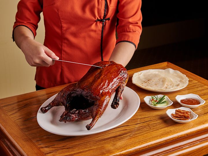 Chef Carving a Roast Duck at Golden Peony