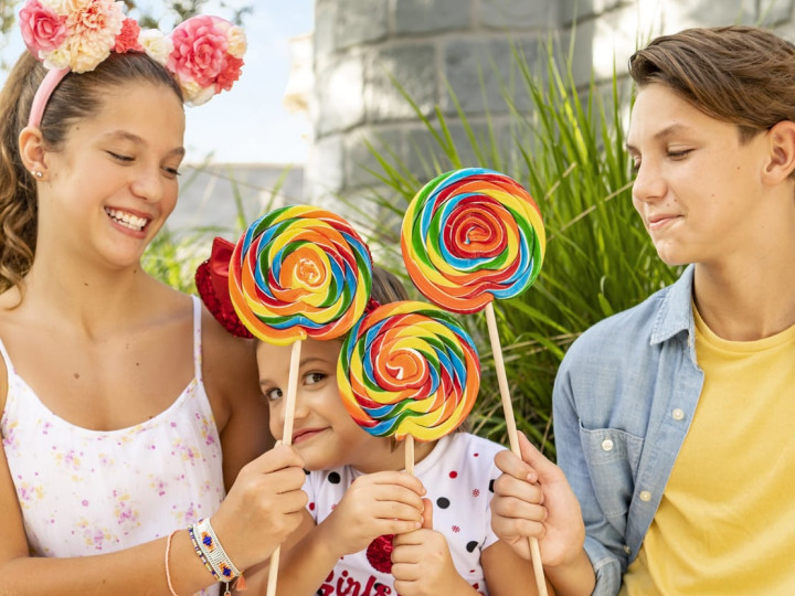 Three children with large lollypops