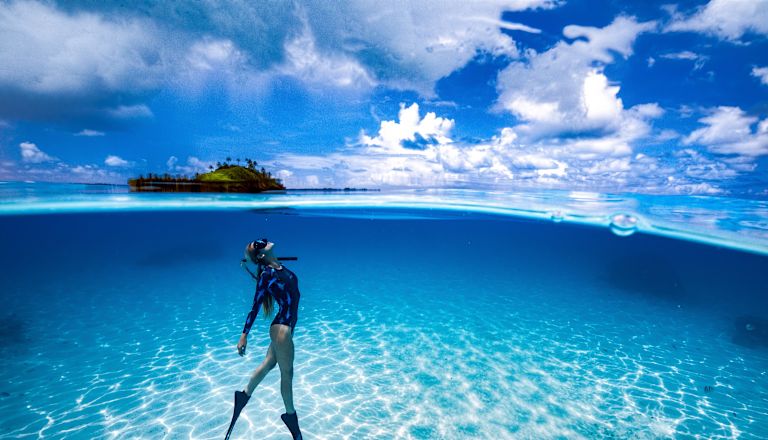 Shot of woman diving underwater