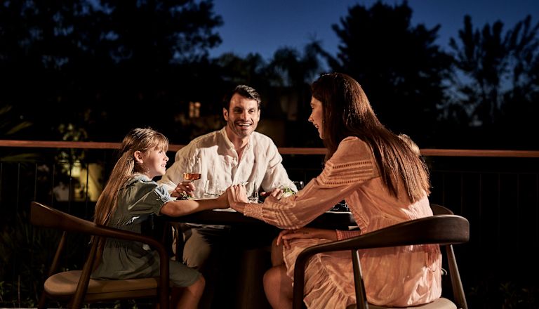 Family Having Dinner in a Terrace at a Restaurant