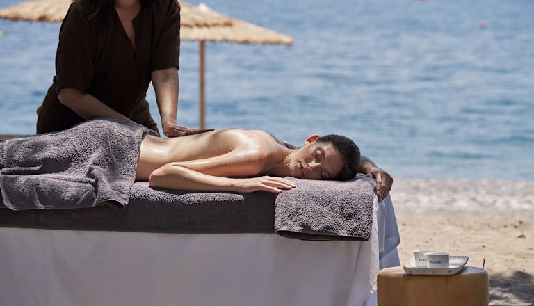 a Woman Getting a Massage at the Beach