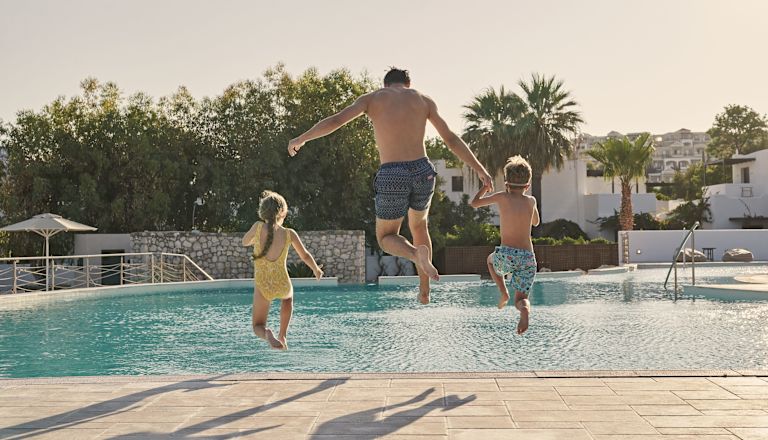 Man with Kids Jumping in the Pool