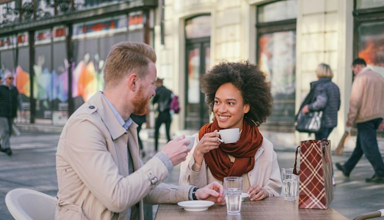 Happy couple having a coffee in the city
