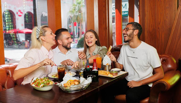 McGettigan's JBR shot, with group of friends laughing around table