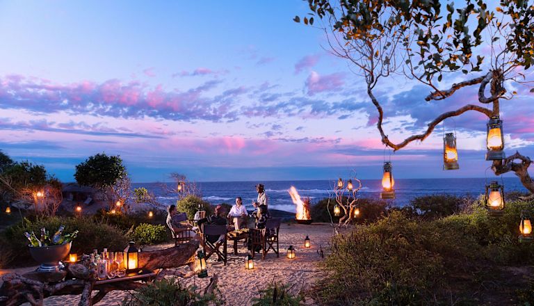 Couple Having Dinner on the Beach at Night