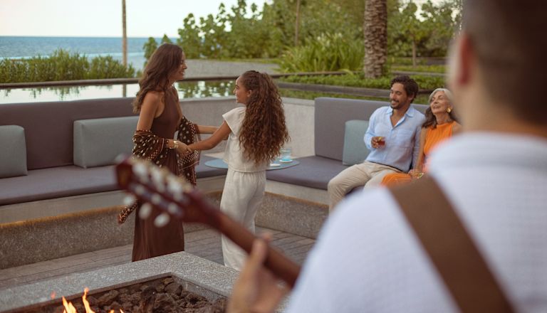 Woman and daughter dancing to live music at the firepit