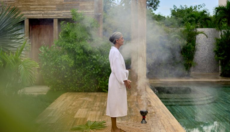 Woman in a bathrobe relaxing in a spa