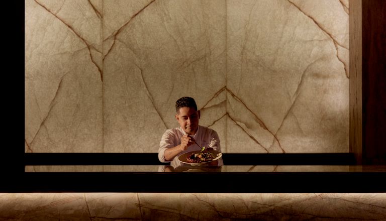 Staff member holding plate of food