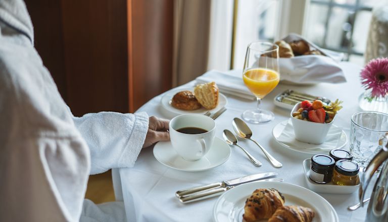 Person Enjoying In Room Dining