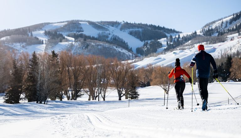 Couple Cross Country Skiing on a Mountain