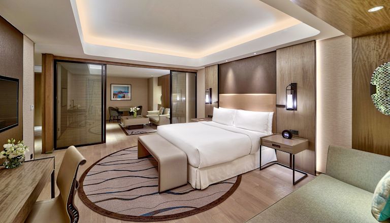 Large Bed in a Hotel Suite with Desk Area