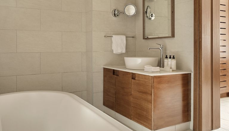 Vanity Area and Bathtub in a Guest Room