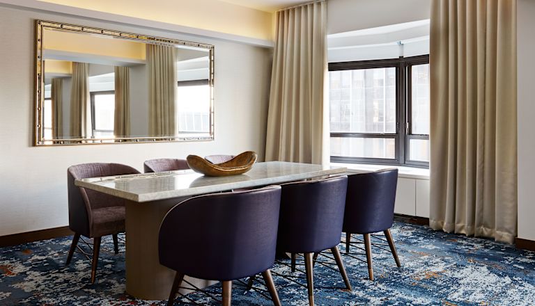 Guest Suite Lounge Area with Dining Table and Armchairs