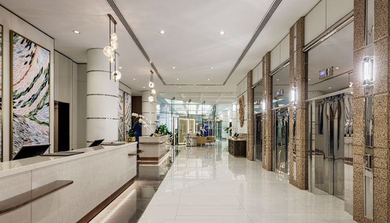 Lobby area with front desk and elevator entrances